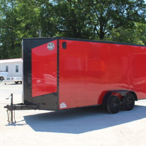 Red enclosed dual-axle cargo trailer on gravel lot