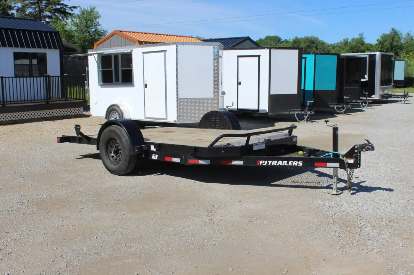Flatbed utility trailer on gravel lot