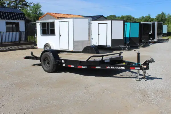Flatbed utility trailer on gravel lot