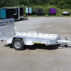 Aluminum utility trailer parked on gravel lot