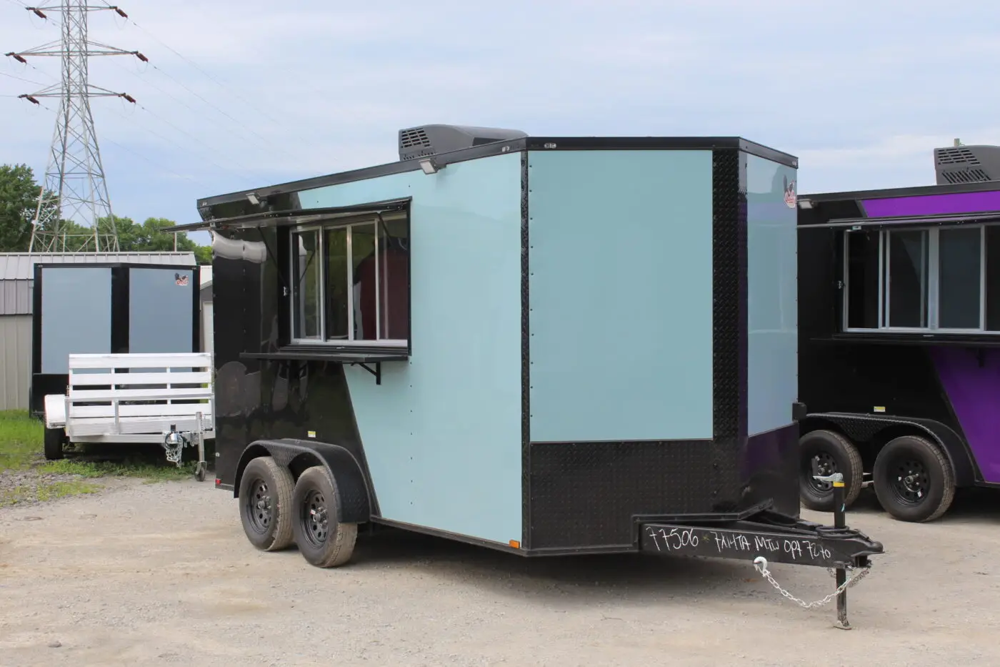 Light blue concession trailer with serving window open