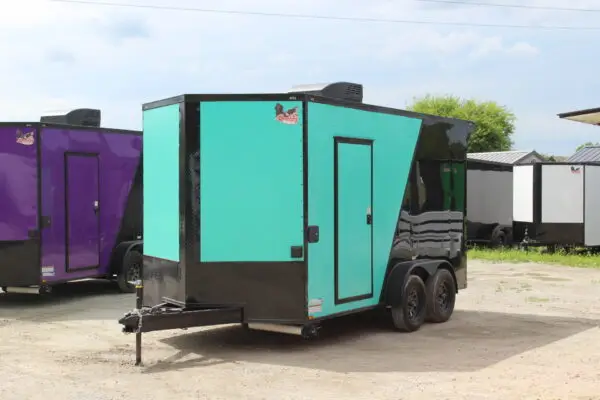 Teal and black enclosed cargo trailer outdoors