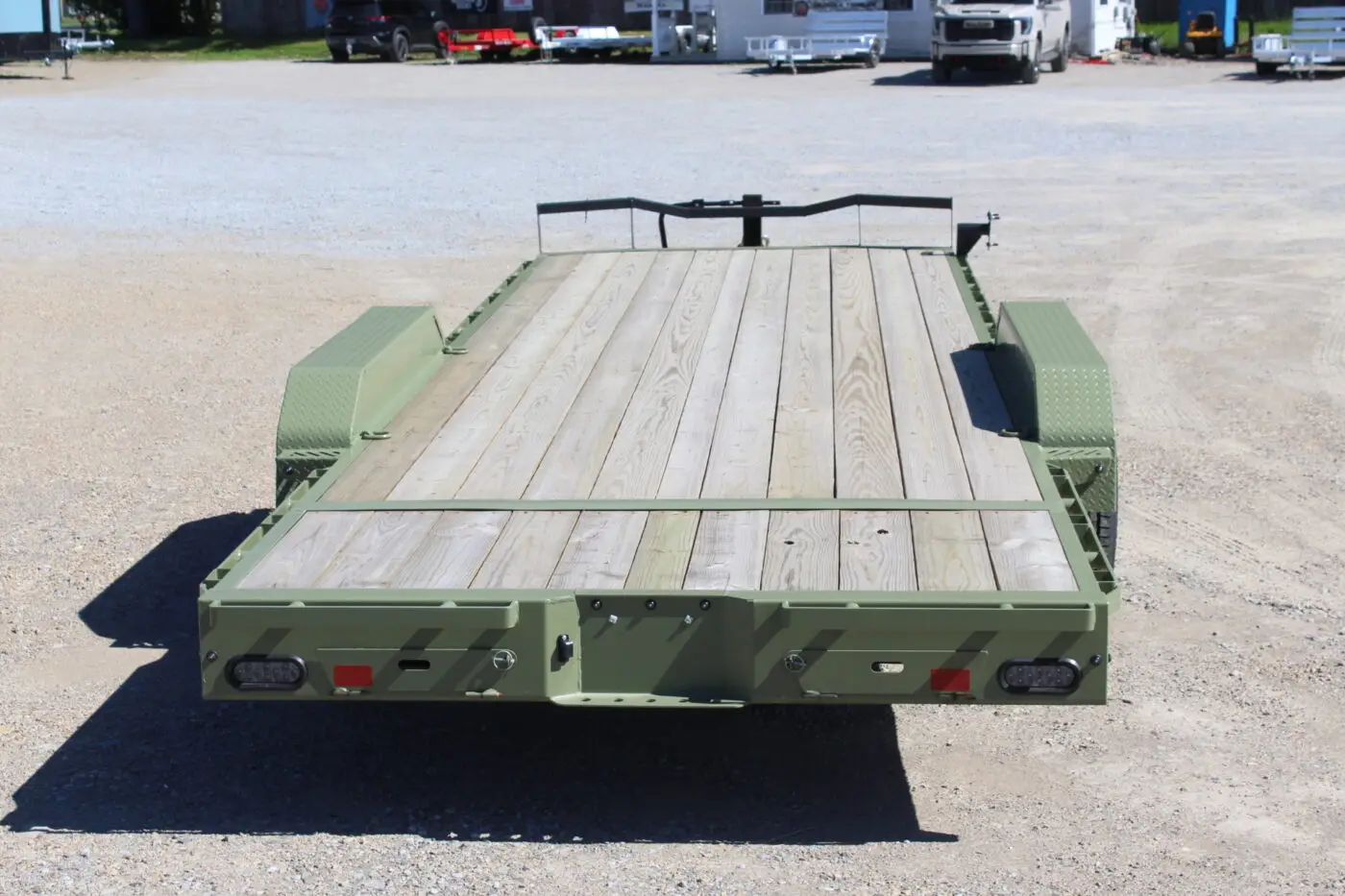 Green flatbed utility trailer with wooden deck