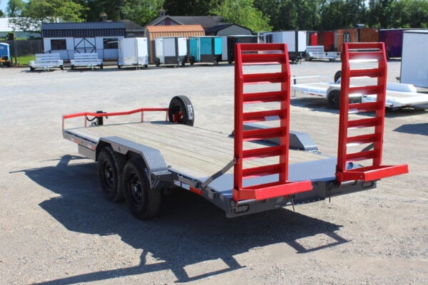 Flatbed equipment trailer with red loading ramps