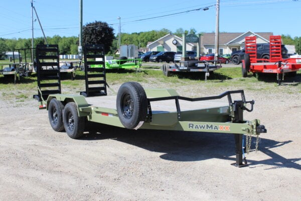 Green dual-axle equipment trailer on gravel lot