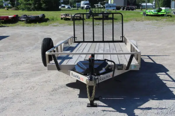 Utility trailer with mesh ramp gate on lot