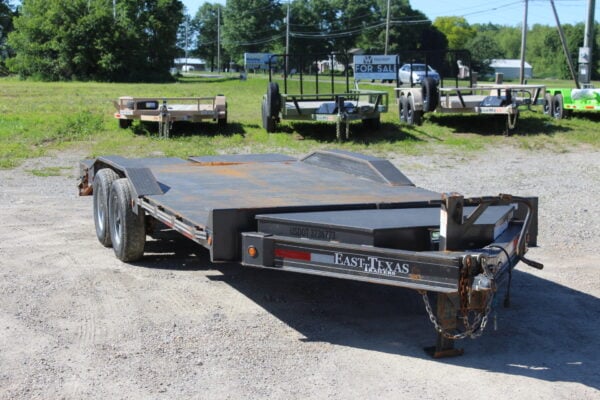 Flatbed utility trailer on gravel lot