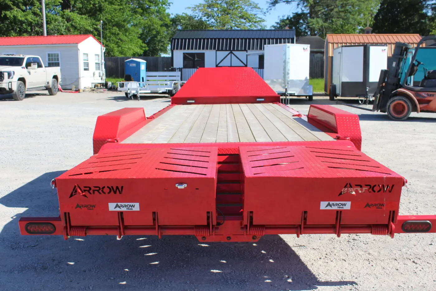 Red Arrow equipment trailer with loading ramps
