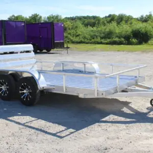 Aluminum dual-axle utility trailer on gravel lot