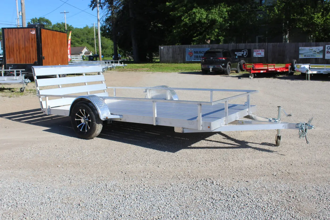 Aluminum utility trailer on gravel lot