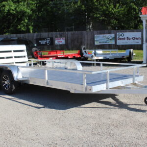 Aluminum dual-axle utility trailer on gravel lot