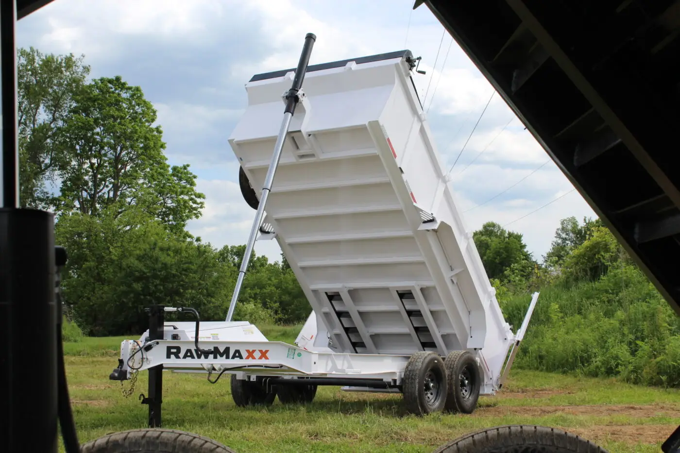 White dump trailer with raised hydraulic bed