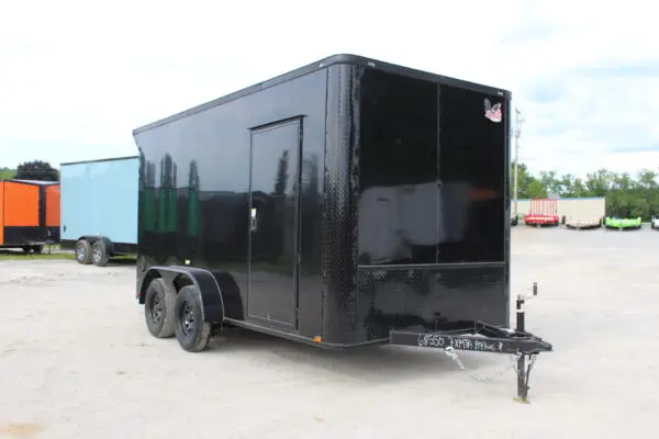 Black enclosed cargo trailer on dealership lot