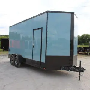 Light blue enclosed cargo trailer on gravel lot
