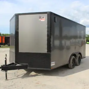 Black enclosed dual-axle cargo trailer on gravel lot