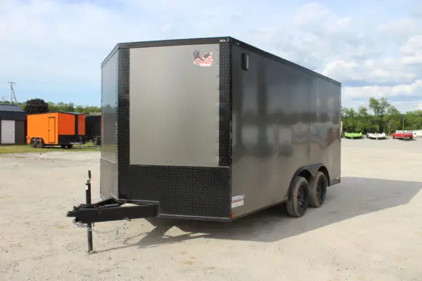 Black enclosed dual-axle cargo trailer on gravel lot