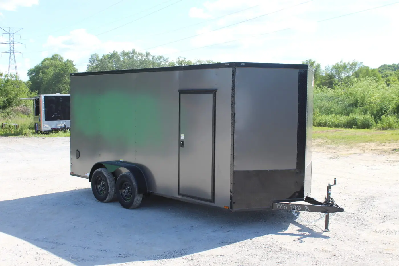 Gray enclosed dual-axle cargo trailer outdoors