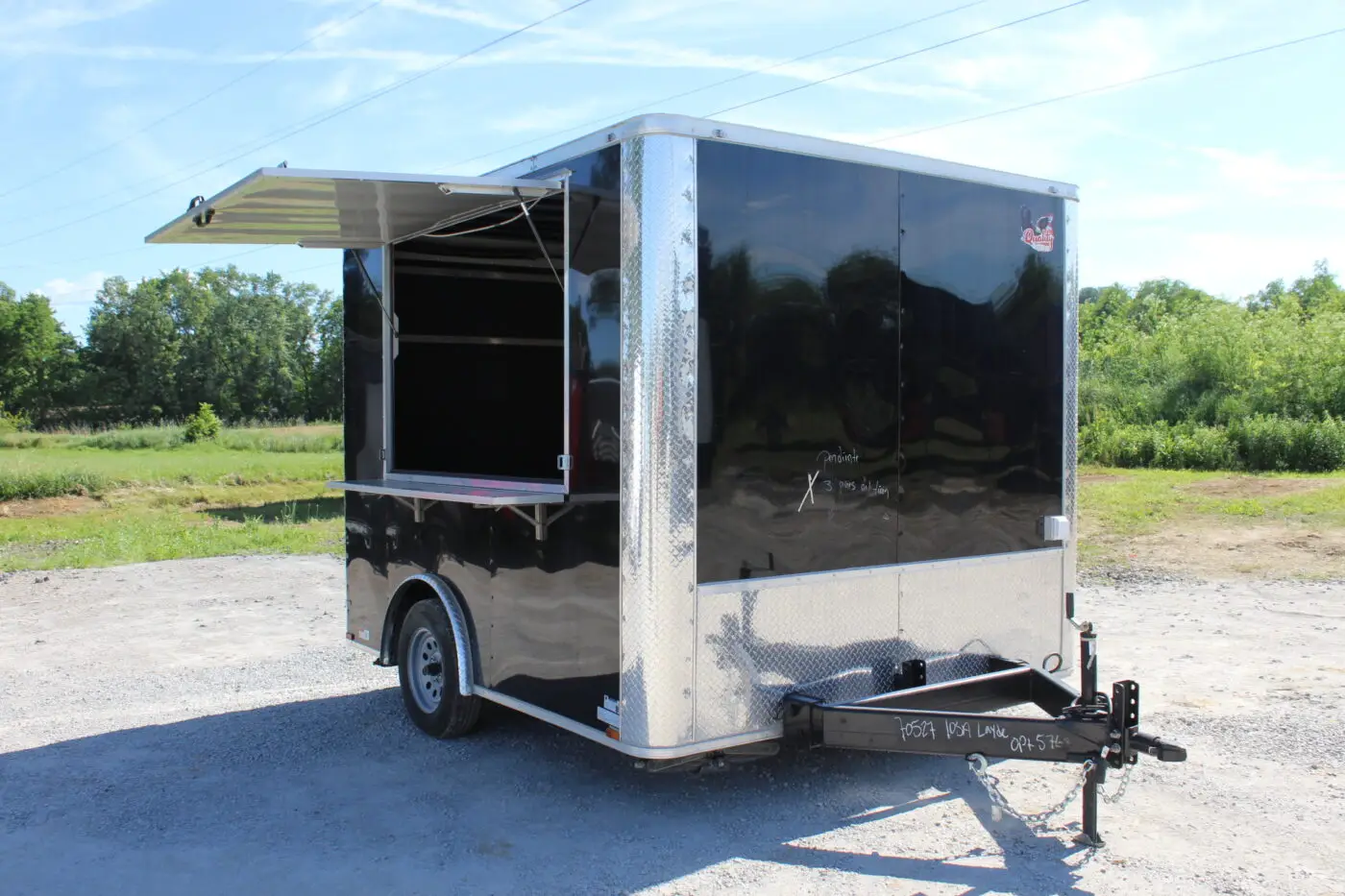 Black enclosed cargo trailer with open serving window