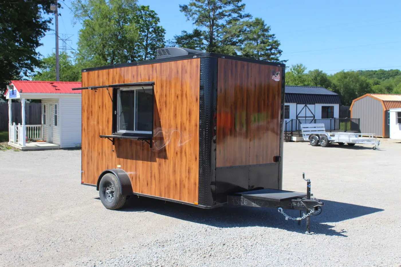 Wood-paneled mobile food trailer with serving window